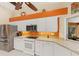 Kitchen with stainless steel appliances, white cabinets, and a large window at 1447 Gleneagles Dr, Venice, FL 34292
