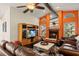Cozy living room with a fireplace, comfortable leather furniture, and a large entertainment center at 1447 Gleneagles Dr, Venice, FL 34292