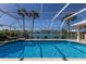 Gorgeous pool surrounded by lush landscaping, offering beautiful lake views at 1447 Gleneagles Dr, Venice, FL 34292