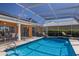 Relaxing screened-in pool offers a private outdoor space, with chairs and lush surroundings at 1447 Gleneagles Dr, Venice, FL 34292