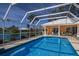 A refreshing screened pool provides the perfect outdoor retreat with a lakeside view at 1447 Gleneagles Dr, Venice, FL 34292