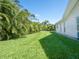 Expansive green backyard with lush tropical foliage and a well-maintained lawn providing serene privacy at 172 Sea Anchor Dr, Osprey, FL 34229
