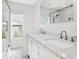 Bathroom featuring double sinks, white cabinets, marble countertops, and a glass shower at 172 Sea Anchor Dr, Osprey, FL 34229