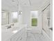 Bright bathroom with white vanity, marble floors, glass shower, and window at 172 Sea Anchor Dr, Osprey, FL 34229