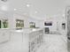 Bright, open kitchen with an island, marble countertops, bar seating, and stainless steel appliances at 172 Sea Anchor Dr, Osprey, FL 34229