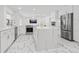 Open-concept kitchen with marble countertops, stainless steel appliances, and a kitchen island at 172 Sea Anchor Dr, Osprey, FL 34229