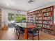Library features a large bookshelf, a large meeting table and a view of the outdoors at 172 Sea Anchor Dr, Osprey, FL 34229