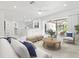 Bright, open-concept living area featuring white furnishings, marble floors, and access to an outdoor patio at 172 Sea Anchor Dr, Osprey, FL 34229