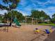 Community playground area featuring swings, a slide, and other play structures for children at 172 Sea Anchor Dr, Osprey, FL 34229