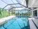Sparkling pool enclosed in a screened lanai with a lush green exterior view at 172 Sea Anchor Dr, Osprey, FL 34229