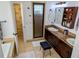 Bathroom with double sinks, dark wood vanity and a walk-in shower at 173 Bath Club N Blvd, North Redington Beach, FL 33708