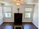 Bright bedroom featuring hardwood floors, a modern ceiling fan and two windows with white wood trim at 173 Bath Club N Blvd, North Redington Beach, FL 33708