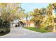 Inviting home exterior with a beautiful brick driveway and lush, mature landscaping at 173 Bath Club N Blvd, North Redington Beach, FL 33708