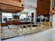 A gourmet kitchen that features granite countertops and top-of-the-line stainless steel appliances at 173 Bath Club N Blvd, North Redington Beach, FL 33708