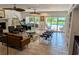 Open-concept living area featuring tile floors, comfortable seating, and sliding doors to the backyard at 173 Bath Club N Blvd, North Redington Beach, FL 33708