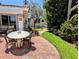 Charming outdoor patio with brick flooring, dining table, and lush landscaping at 173 Bath Club N Blvd, North Redington Beach, FL 33708