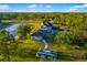 Stunning property with a peaceful pond, garden, and play set on sprawling green acreage at 19006 69Th E Ave, Bradenton, FL 34211
