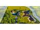 Estate aerial view featuring a private pond, pool, a large garage, and landscaped grounds at 19006 69Th E Ave, Bradenton, FL 34211