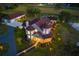 Stunning aerial view of an estate home with a barn, screened pool, pond, and lush landscaping all around at 19006 69Th E Ave, Bradenton, FL 34211