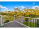The balcony overlooks an expansive lawn area and mature trees, offering scenic views at 19006 69Th E Ave, Bradenton, FL 34211