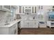 Stylish bar area features custom white cabinetry, elegant countertops, and modern fixtures at 19006 69Th E Ave, Bradenton, FL 34211
