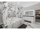 Luxurious bathroom featuring a soaking tub, marble tiling and a dual sink vanity at 19006 69Th E Ave, Bradenton, FL 34211