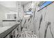 Luxurious bathroom featuring a rain head shower, marble tiling and a dual sink vanity at 19006 69Th E Ave, Bradenton, FL 34211