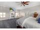 Spacious bedroom featuring a ceiling fan, a lounge chair and connecting ensuite at 19006 69Th E Ave, Bradenton, FL 34211