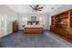 Spacious bedroom featuring a ceiling fan, built in shelving and blue carpet at 19006 69Th E Ave, Bradenton, FL 34211
