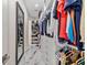 Walk-in closet featuring custom shelving, drawers, with a mirrored accent at 19006 69Th E Ave, Bradenton, FL 34211