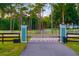 Grand entrance featuring a gated driveway with elegant landscaping, providing secure access at 19006 69Th E Ave, Bradenton, FL 34211