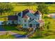 Gorgeous aerial view of a stately two-story home with attached garage, porch, beautiful landscaping, and a circular driveway at 19006 69Th E Ave, Bradenton, FL 34211