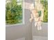 Bright foyer area featuring modern chandelier and large windows showcasing the lush surrounding landscape at 19006 69Th E Ave, Bradenton, FL 34211