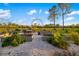 Charming raised garden beds with gravel walkways and an arched trellis for gardening enthusiasts at 19006 69Th E Ave, Bradenton, FL 34211