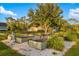 Beautiful garden area features an attractive dining area with table, lush greenery, and raised beds at 19006 69Th E Ave, Bradenton, FL 34211