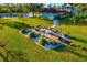 Beautiful raised garden beds with rock surround, table and potting station, on a sprawling lawn with a pond in the background at 19006 69Th E Ave, Bradenton, FL 34211