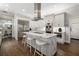 Bright kitchen features a central island with sleek stainless steel appliances and stylish white cabinetry at 19006 69Th E Ave, Bradenton, FL 34211