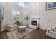 Bright living room with fireplace, soaring ceilings, large windows, and elegant decor at 19006 69Th E Ave, Bradenton, FL 34211