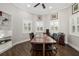 Bright home office features hardwood floors, plantation shutters, built-in shelving, and stylish decor at 19006 69Th E Ave, Bradenton, FL 34211