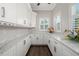 Bright pantry features white cabinets and plenty of counter space, perfect for food prep at 19006 69Th E Ave, Bradenton, FL 34211