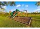 Backyard playground has swings, slides, and a climbing structure, great for outdoor fun at 19006 69Th E Ave, Bradenton, FL 34211