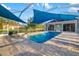 A covered pool and spa area with brick pavers are perfect for relaxation at 19006 69Th E Ave, Bradenton, FL 34211