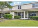 View of a screened-in back porch with manicured landscaping and a well-maintained lawn at 2353 Rosewood Ln, North Port, FL 34289