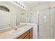 Clean bathroom with a glass-enclosed shower, vanity, and well-lit mirror at 2353 Rosewood Ln, North Port, FL 34289