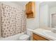 Well-maintained bathroom with a combined tub and shower, vanity, and neutral color palette at 2353 Rosewood Ln, North Port, FL 34289