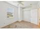 Simple bedroom featuring a closet, carpeting, a ceiling fan, and ample natural light at 2353 Rosewood Ln, North Port, FL 34289