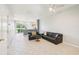 Comfortable living room with neutral paint, tile floors, ceiling fan, and an open kitchen layout at 2353 Rosewood Ln, North Port, FL 34289