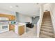 Open-concept living space with tile floors, stairs, and a combined kitchen and living room at 2353 Rosewood Ln, North Port, FL 34289