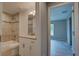 Updated bathroom featuring granite countertop vanity and tile shower, adjacent to a bedroom at 25 Sabot Ct, Placida, FL 33946