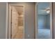 Bathroom view showcasing tub/shower with tile surround and view into adjacent bedroom at 25 Sabot Ct, Placida, FL 33946